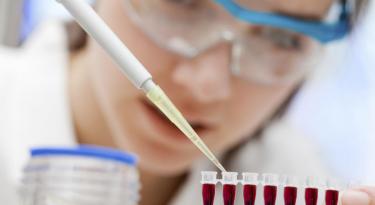 Researcher using a pipet